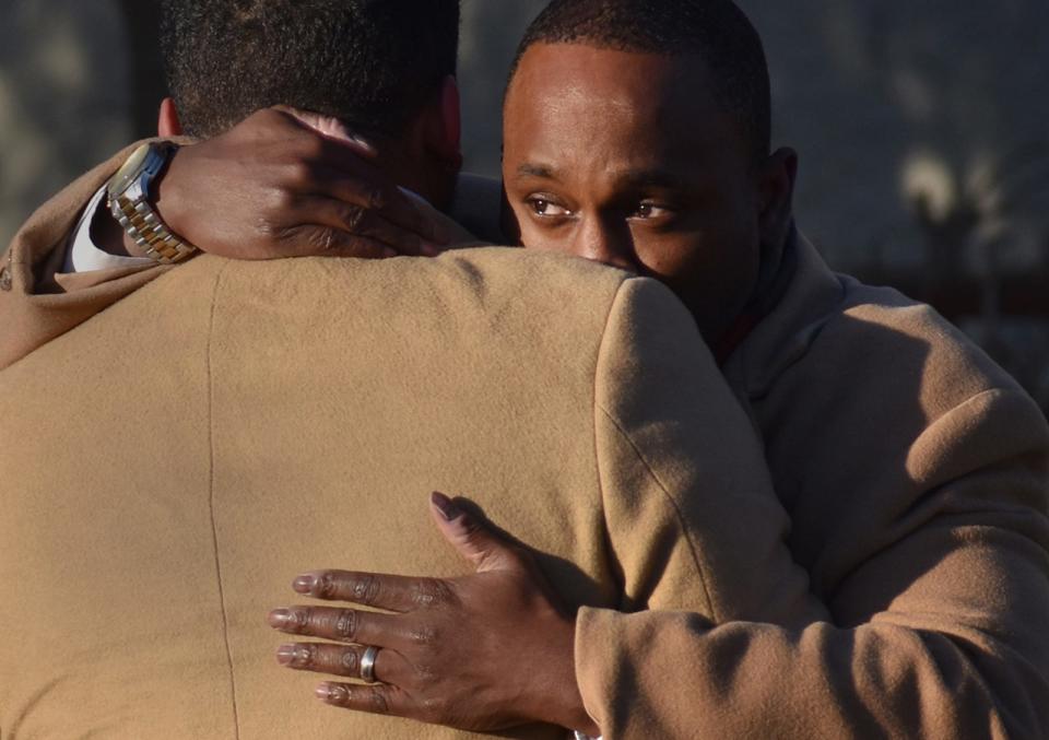 Anthony Harden's brothers, Eric B. Mack and Antone Harden hug at a rally in Fall River's Britland Pak Saturday to demand police transparency in the fatal police shooting of Anthony Harden. 