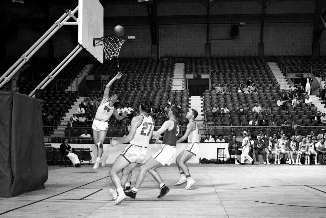 Jesse “J.B.” Renick scores against Switzerland at Harringay Arena in London on July 30, 1948. No. 27 in the foreground is Kentucky basketball player Wallace “Wah Wah” Jones, one of five Wildcats on the USA Olympic Team that year.