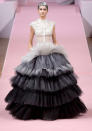 <b>Alexis Mabille Haute Couture SS13</b> <br><br>A tiered, ball gown in shades of grey and black highlighted the futuristic make up.<br><br>© Rex