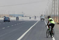 Egyptian cyclist Helmy El Saeed, 27, rides his bicycle on the highway of El Ain El Sokhna, east of Cairo, Egypt July 19, 2017. REUTERS/Amr Abdallah Dalsh