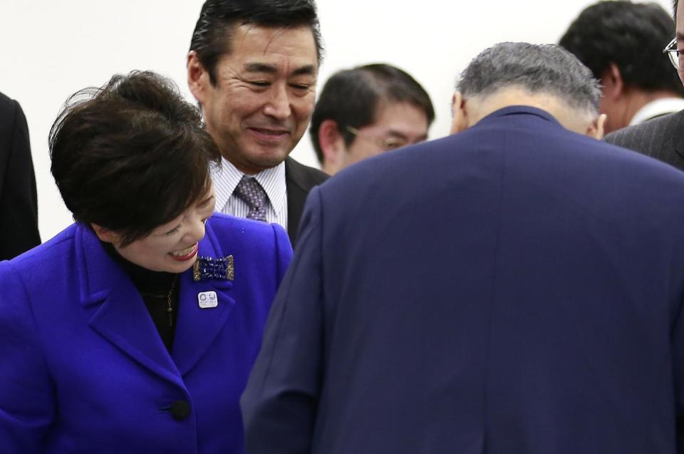 Tokyo Gov. Yuriko Koike greets Tokyo Olympics Organizing Committee President Yoshiro Mori after the four-party working group meeting in Tokyo, Wednesday, Dec. 21, 2016. Organizers of the Tokyo Olympics estimate the total cost to host the 2020 Games will be between 1.6 and 1.8 trillion yen ($13-$15 billion). The official cost estimate announced Wednesday was slightly below the promised 2 trillion ($17 billion) cap. (AP Photo/Shizuo Kambayashi)