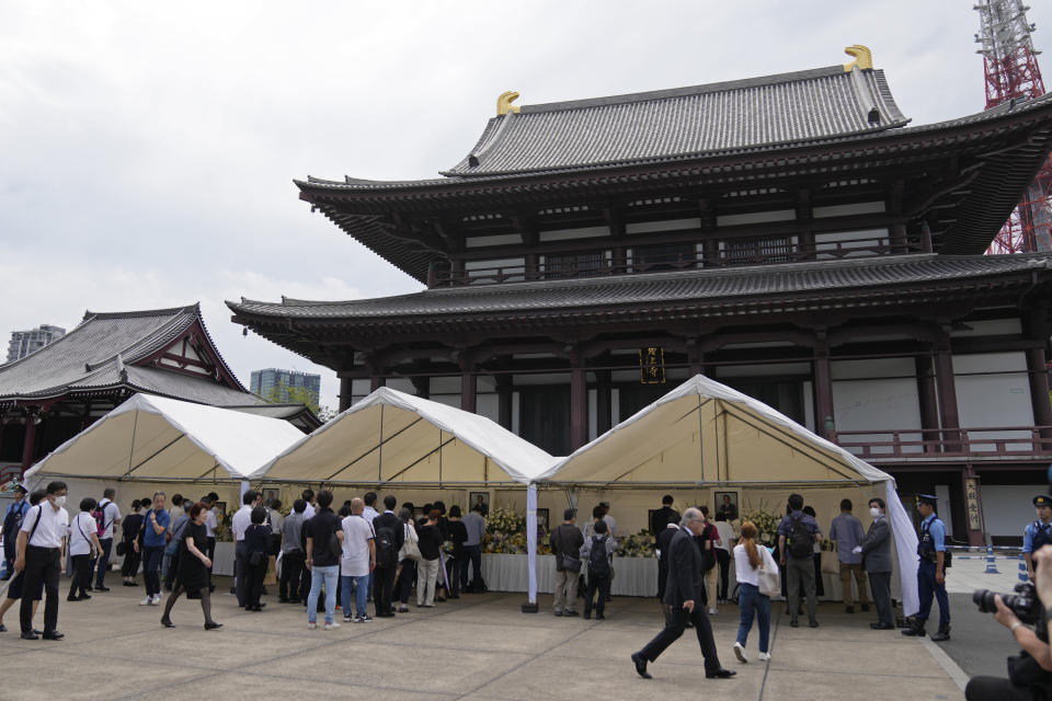 People offer prayers for former Prime Minister Shinzo Abe at Zojoji temple in Tokyo, Japan, Saturday, July 8, 2023. Japan marked first anniversary of the death of Abe who was shot while giving an outdoor campaign speech.(AP Photo/Shuji Kajiyama)