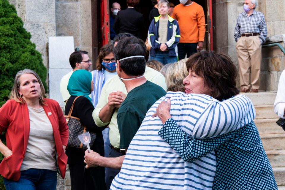 People hug each other at the end of a vigil to stand in solidarity with the Uvalde, Texas, families and demand an end to gun violence at Trinity Episcopal Church on Thursday, 26 May 2022 (AP)