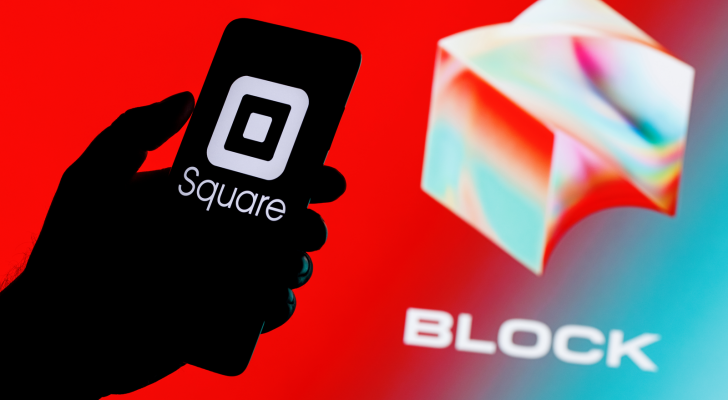 Square, Inc. changes name to Block (SQ). Smartphone with Square logo on screen in hand on background of Block logo.