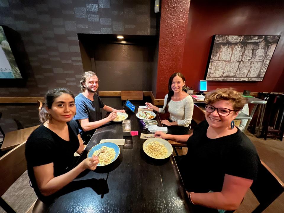 Restaurant employees at Mayan Cafe in Louisville share a "family meal" at the restaurant.