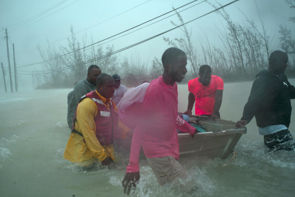 Volunteers rescue several families from the rising waters of Hurricane Dorian, near the Causarina bridge in Freeport, Grand Bahama, Bahamas, Tuesday, Sept. 3, 2019. The storm’s punishing winds and muddy brown floodwaters devastated thousands of homes, crippled hospitals and trapped people in attics. (AP Photo/Ramon Espinosa)