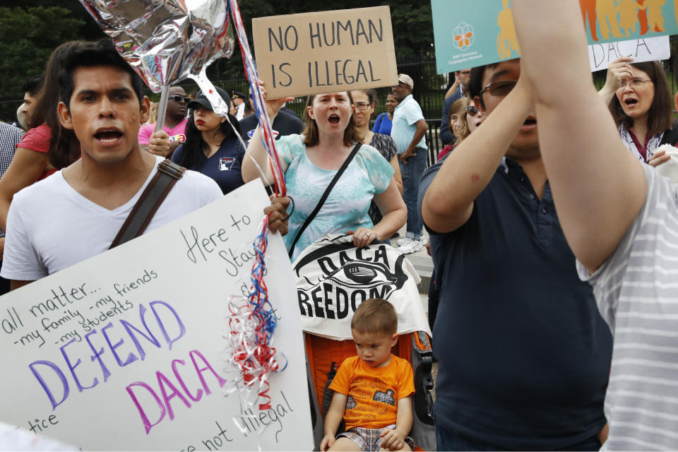 <p>Laurel Hoa, of Kensington, Md., center, holds up a sign that says “no human is illegal,” with her son Gabe Hoa, 3, during a rally in support of the Deferred Action for Childhood Arrivals program known as DACA, outside of the White House, in Washington, Tuesday, Sept. 5, 2017. (Photo: Jacquelyn Martin/AP) </p>