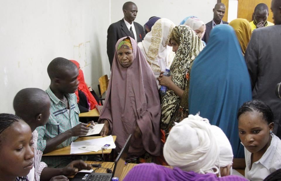 FILE - In this Wednesday, April 9, 2014 file photo, detained Somali women are fingerprinted and screened at the Kasarani sports stadium, Nairobi, Kenya. Kenya deported 91 more Somali nationals to Mogadishu on Thursday, April 17, 2014, the second wave of forced deportations that UNHCR warned could be endangering Somalis in need of protection from militants. But it is because of the steady drumbeat of terror attacks blamed on al-Shabab and its sympathizers that Kenya is now carrying out a massive security operation that threatens to open the country’s ethnic fault lines. Police say they are not targeting Somalis but instead are hunting terrorism suspects and illegal aliens. But rights groups say Somalis are bearing the brunt of police actions, including monetary shakedowns and physical and sexual abuses. Most Kenyans applaud the operation. (AP Photo/Khalil Senosi, File)