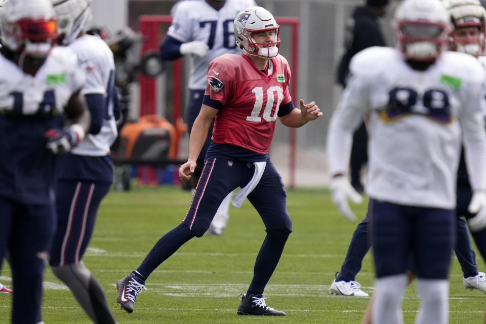 New England Patriots quarterback Mac Jones (10) works out with teammates during NFL football practice, Wednesday, Oct. 18, 2023, in Foxborough, Mass. (AP Photo/Charles Krupa)