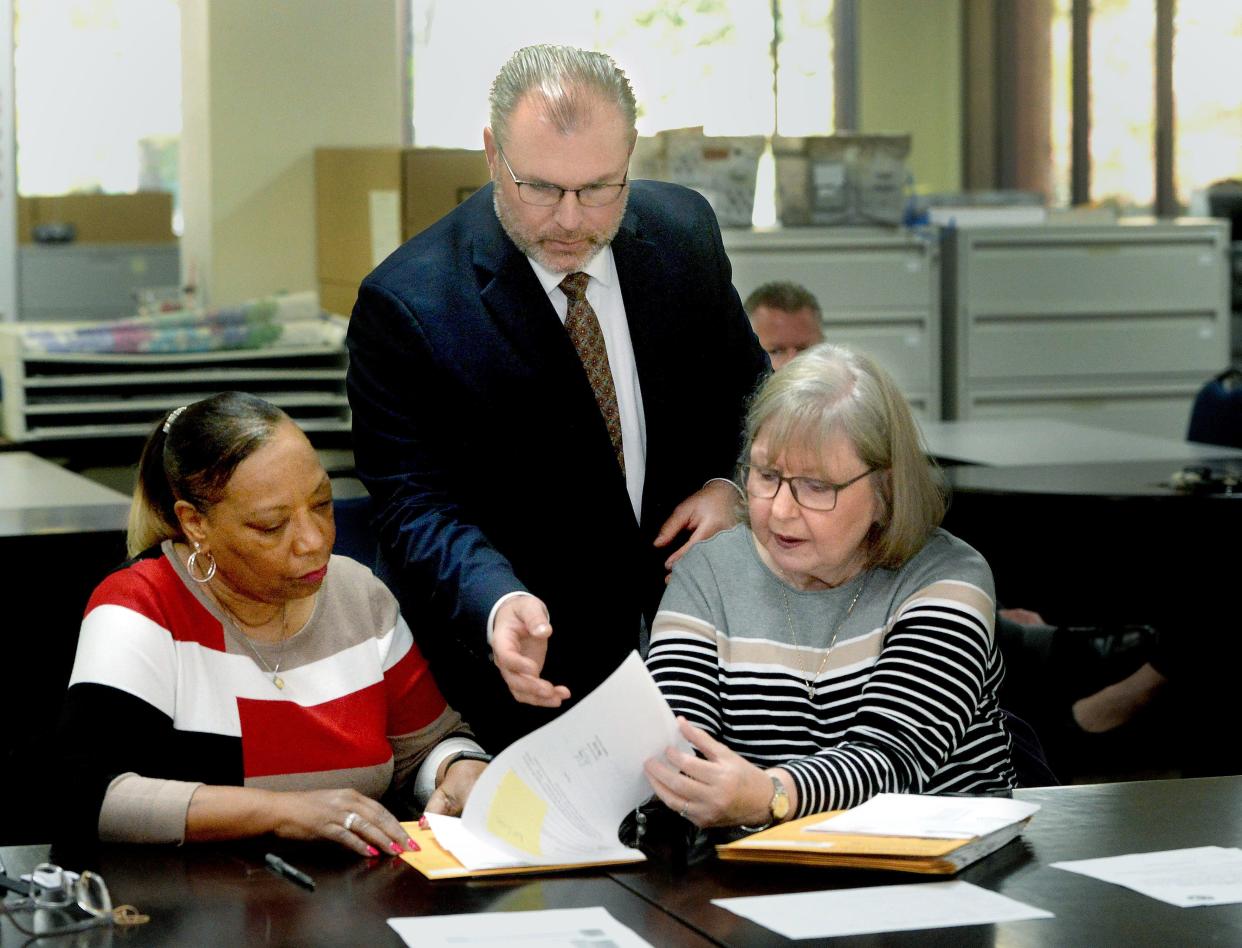 Sangamon County clerk Don Gray, center, goes over ballots with election judges Pamela Stowe, left, and Sheila Murdock at Sangamon County Building South on Tuesday, April 18, 2023.