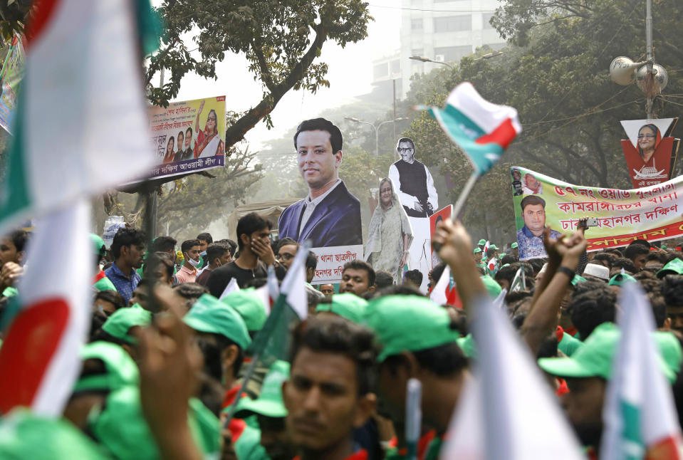 Supporters hold cut-outs of the Awami League political party leaders during a rally celebrating the party's overwhelming victory in last month's election in Dhaka, Bangladesh, Saturday, Jan. 19, 2019. (AP Photo)