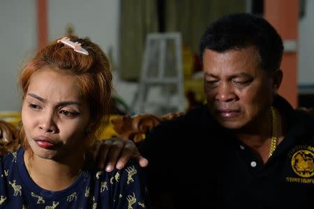 Jiranuch Trirat is comforted her by father at a temple in Phuket, Thailand April 25, 2017. REUTERS/Sooppharoek Teepapan