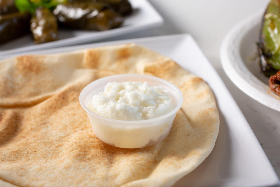 Toum, a Lebanese garlic sauce, on a slice of pita bread