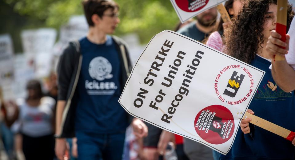 Demonstrators march outside of Ballentine Hall on campus during the graduate student worker strike on Wednesday, April 17, 2024.