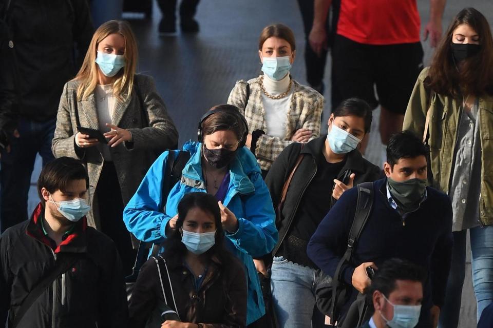 Commuters wearing face coverings at Waterloo Station in London: PA