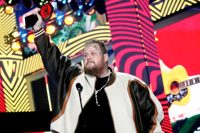 <p>Jeff Kravitz/Getty</p> Jelly Roll accepts one of his prizes at the CMT Awards on April 7, 2024 in Austin, Texas