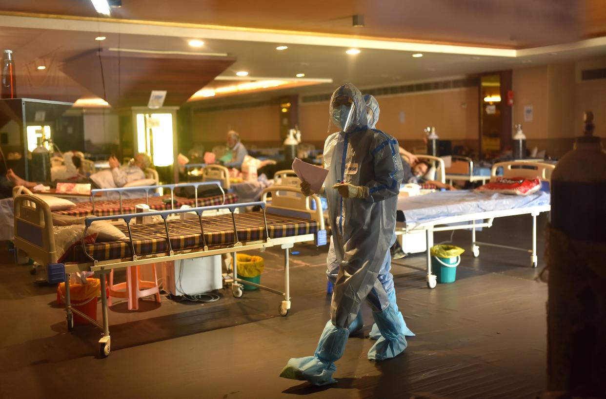 <p>Doctors wearing Personal Protective Equipment (PPE) walk after examining patients inside a COVID-19 care center and isolation ward facility near a Hospital in New Delhi, India, as the country struggles in the grip of an unprecedented health crisis amid Covid-19 pandemic and vaccine shortages</p> (EPA)