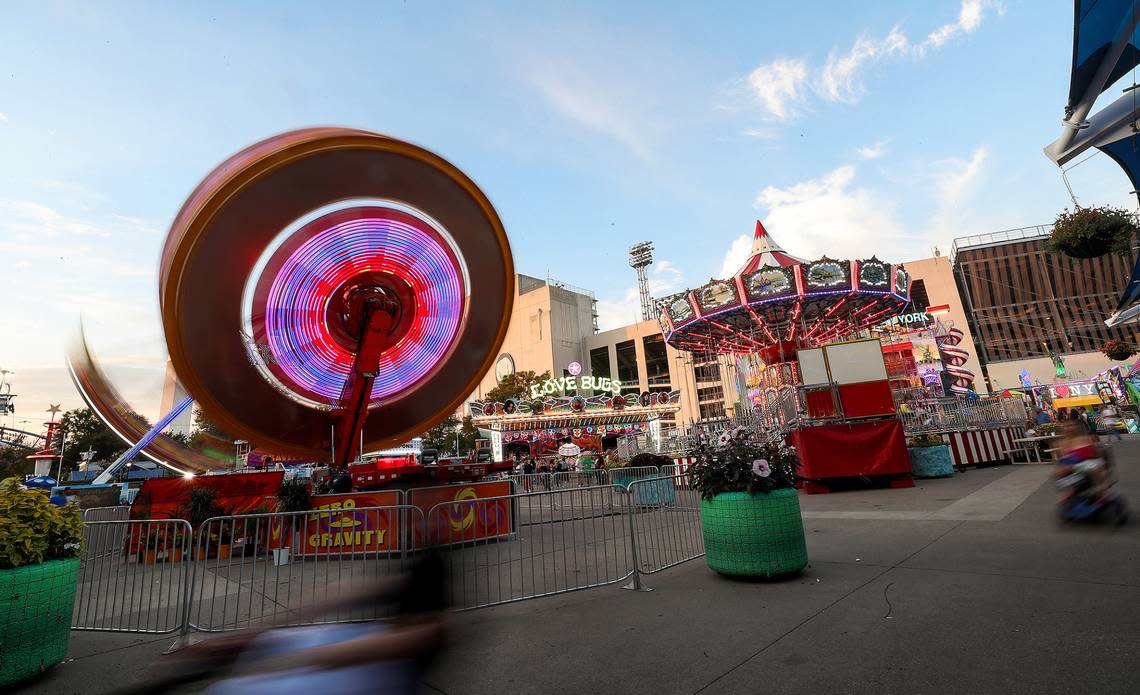 Fair ride lights begin to glow as the sun sets on opening day of the State Fair of Texas on Friday, September 24, 2021.