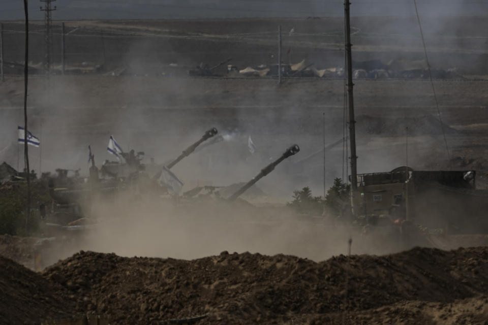 Israeli artillery fires near the border with the Gaza Strip on Tuesday, Oct. 31, 2023. Over the past five days, Israeli ground troops have pushed deeper and deeper into Gaza in their war against Hamas, launched in response to a bloody Oct. 7 cross-border raid by the Islamic militant group. Yet even as the operation expands each day, the army refuses to call it an invasion. Its vague choice of words appears to be a deliberate strategy aimed at keeping its enemy off balance and preserving its options as a lengthy war unfolds. (AP Photo/Ariel Schalit)