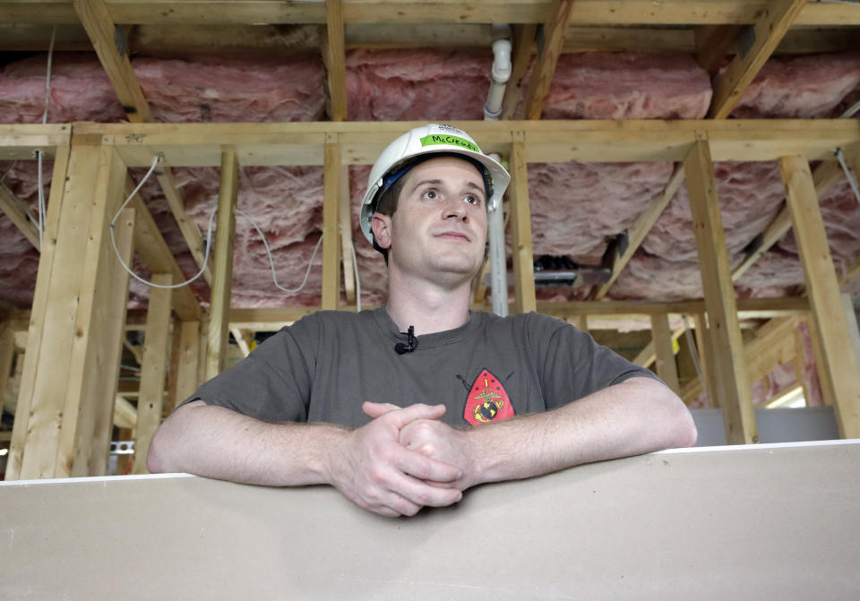 FILE - In this Sept. 26, 2018 file photo, Democratic congressional candidate Dan McCready, left, leans against wallboard as he pauses during a Habitat For Humanity building event in Charlotte, N.C. North Carolina election officials agreed Friday, Nov. 30, to hold a public hearing into alleged “numerous irregularities” and “concerted fraudulent activities” involving traditional mail-in absentee ballots in the 9th Congressional District, apparently in two rural counties. Republican Mark Harris leads McCready by 905 votes from nearly 283,000 cast in all or parts of eight south-central counties reaching from Charlotte to near Fayetteville. (AP Photo/Chuck Burton, File)