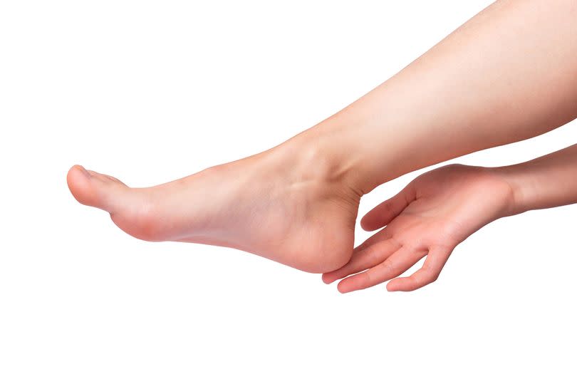 Getty generic. Female feet and hands on white, Foot care concept.