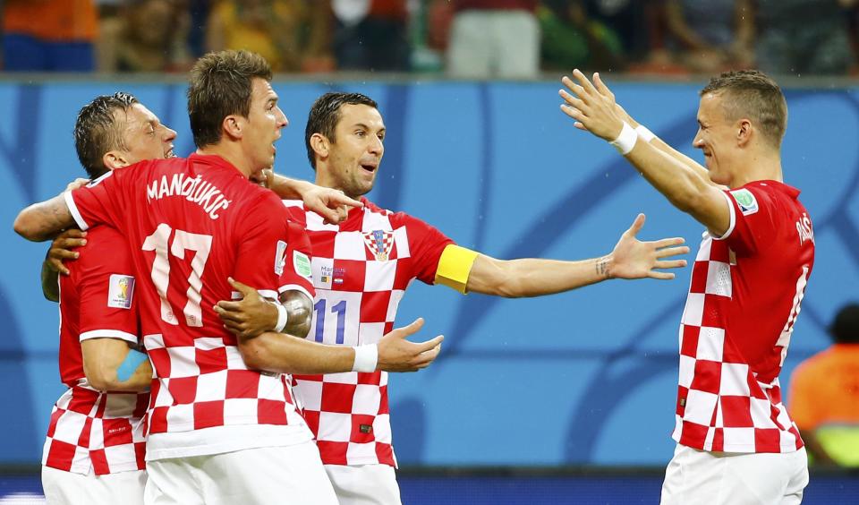 Croatia's Ivica Olic (L) celebrates his goal against Cameroon with his teammates during their 2014 World Cup Group A soccer match at the Amazonia arena in Manaus June 18, 2014. REUTERS/Murad Sezer (BRAZIL - Tags: SOCCER SPORT WORLD CUP)