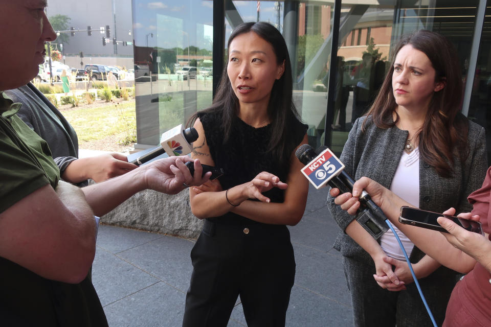 Alice Wang, a Center for Reproductive Rights attorney who is helping Kansas abortion providers challenge a new state law over how providers dispense abortion medications, talks to reporters following a hearing in Johnson County District Court, Tuesday, Aug. 8, 2023, outside the county courthouse in Olathe, Kan. (AP Photo/John Hanna)