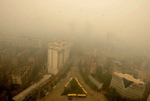 A thick yellow cloud covers a busy intersection in Wuhan on June 11. Wuhan was blanketed by thick yellowish cloud Monday, raising fears of pollution among its nine million inhabitants, residents told AFP. Witnesses said the haze appeared suddenly in the morning, and residents rushed to put on face masks