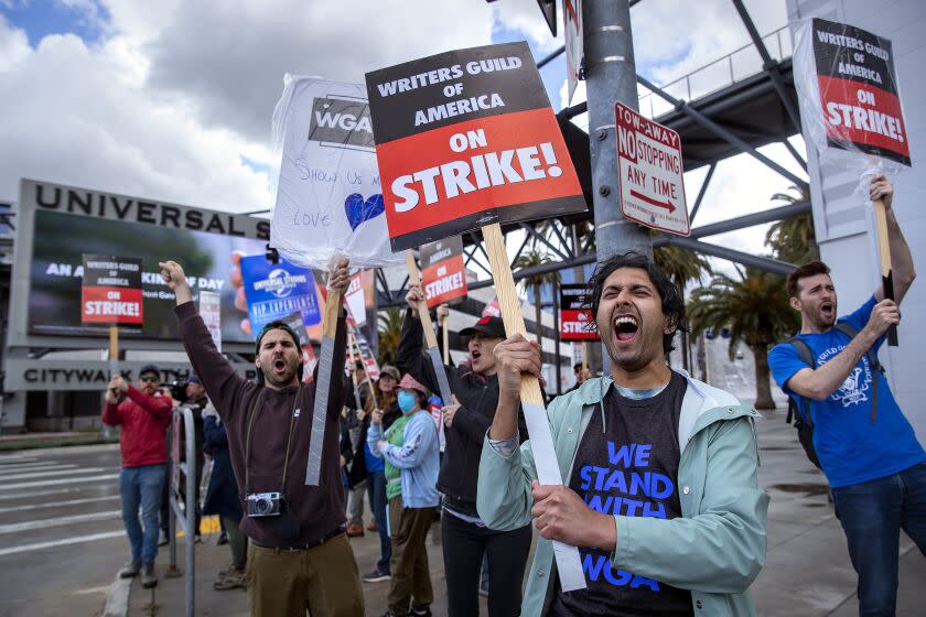 UNIVERSAL CITY, CA-MAY 4, 2023:Cheech Manohar, 2nd from right, a writer and actor, strikes with other members of the Writers Guild of America outside of NBC/Universal Studios in Universal City. (Mel Melcon / Los Angeles Times)