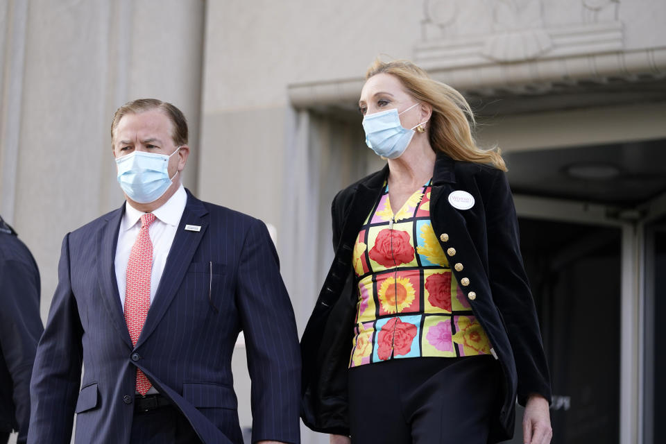 FILE - In this Oct. 14, 2020, file photo, Mark and Patricia McCloskey leave following a court hearing, in St. Louis. The couple, who face charges for waving guns at racial injustice protesters near their St. Louis home in June, are asking a judge to remand the case back to the grand jury for reconsideration. Attorney Joel Schwartz's motion cites a judge's decision in December to take the case away from St. Louis Circuit Attorney Kim Gardner and appoint a special prosecutor because Gardner made reference to the case in political fundraising emails. (AP Photo/Jeff Roberson, File)