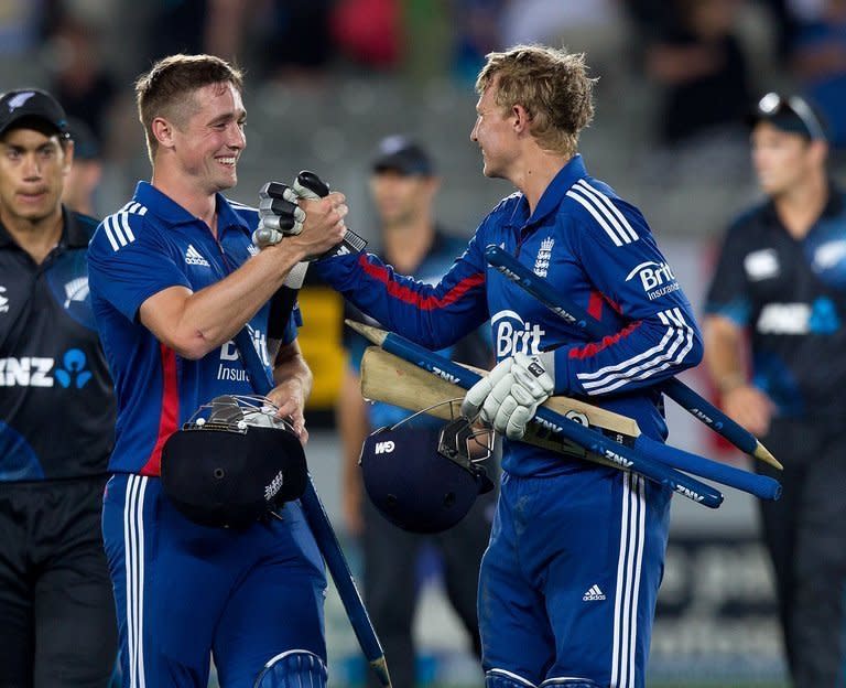 England's Chris Woakes (L) and Joe Root celebrate victory in the third and final one-day international against New Zealand in Auckland on February 23, 2013. Devastating bowling from Steven Finn and a solid top-order batting display gave England a five wicket win at Eden Park to claim the series 2-1