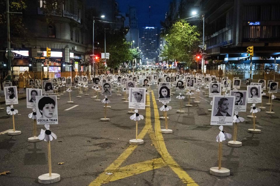 The images of those who disappeared during the military dictatorship are displayed in downtown Montevideo, Uruguay, Thursday, May 20, 2021. The annual March of Silence, which honors the disappeared, was suspended for a second year in a row due to the COVID-19 pandemic. (AP Photo/Matilde Campodonico)