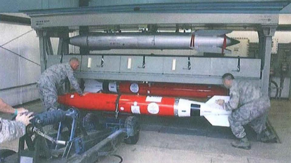 Air Force personnel fit check unarmed B61-12 "shapes" inside a secure storage system at an undisclosed base in Europe. Under NATO nuclear sharing agreements, the U.S. military could release B61 bombs to certain members of the alliance in the event of a serious enough crisis. <em>USAF via DODIG/FOIA </em>