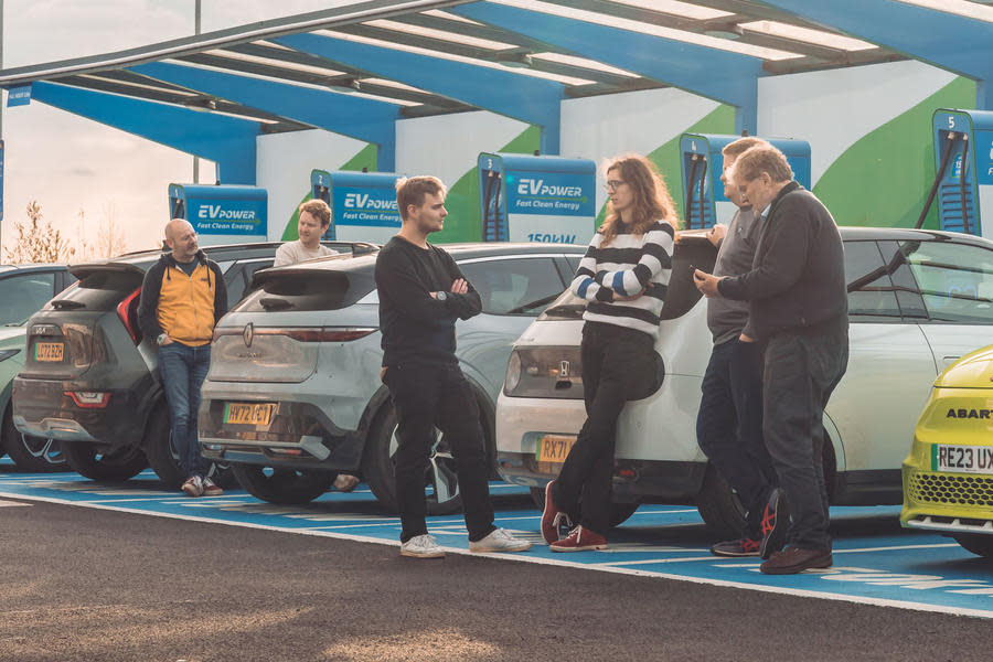 Road testers gathered around a Kia Niro EV, Renault Megane E-Tech, Honda E and Abarth 500e