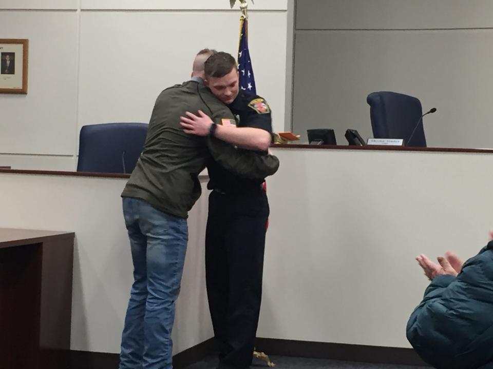 New Shelby police Officer Ethan Yates hugs his brother Zach after being sworn in Friday.