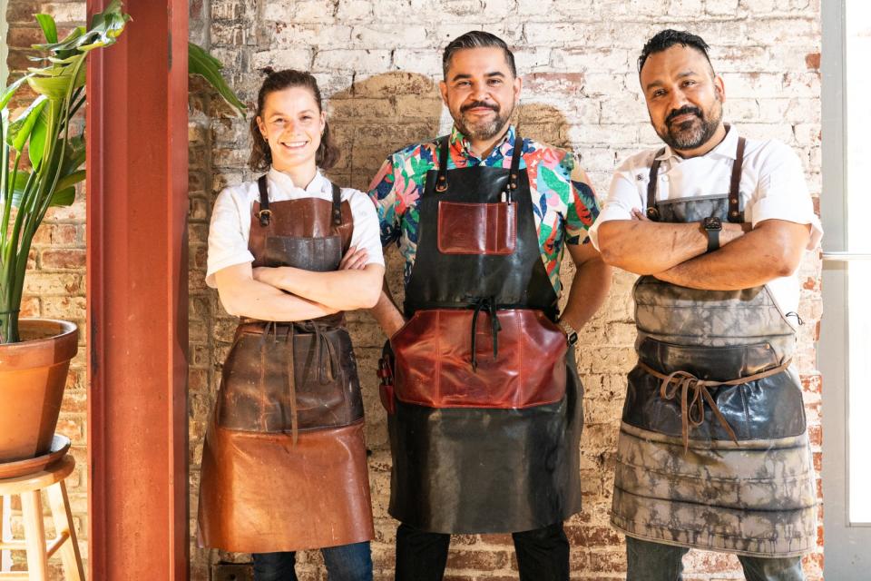 Three chefs standing for a portrait.