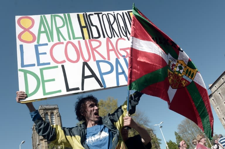 Jean-Baptiste Redde or " Voltuan", a well-known protester in France for his placards, holds a sign reading: "Historic April 8, the courage of peace" at a rally in Bayonne