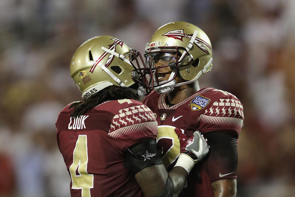 ORLANDO, FL - SEPTEMBER 05: Deondre Francois #12 (R) celebrates with Dalvin Cook #4 after throwing a touchdown pass to Ryan Izzo #81 of the Florida State Seminoles (not pictured) in the third quarter against the Mississippi Rebels during the Camping World Kickoff at Camping World Stadium on September 5, 2016 in Orlando, Florida. (Photo by Streeter Lecka/Getty Images)