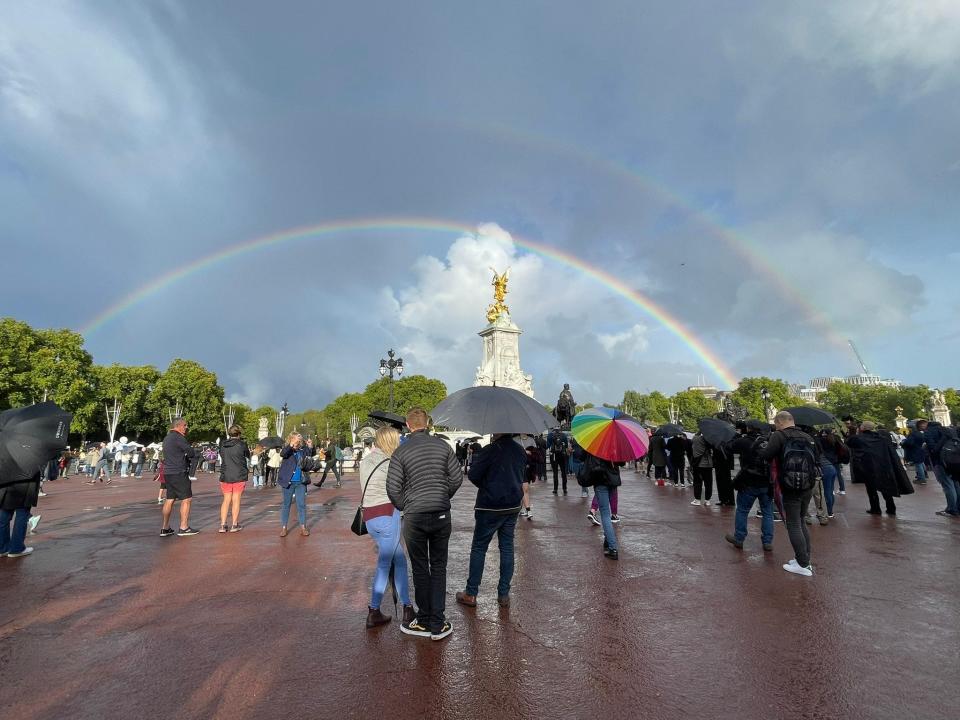 A rainbow is seen beyond the Queen Victoria Memorial, opposite Buckingham Palace, in London on Thursday. People gathered around Buckingham Palace after the announcement of the death of Queen Elizabeth II. Britain's longest-reigning monarch, died Thursday after 70 years on the throne.