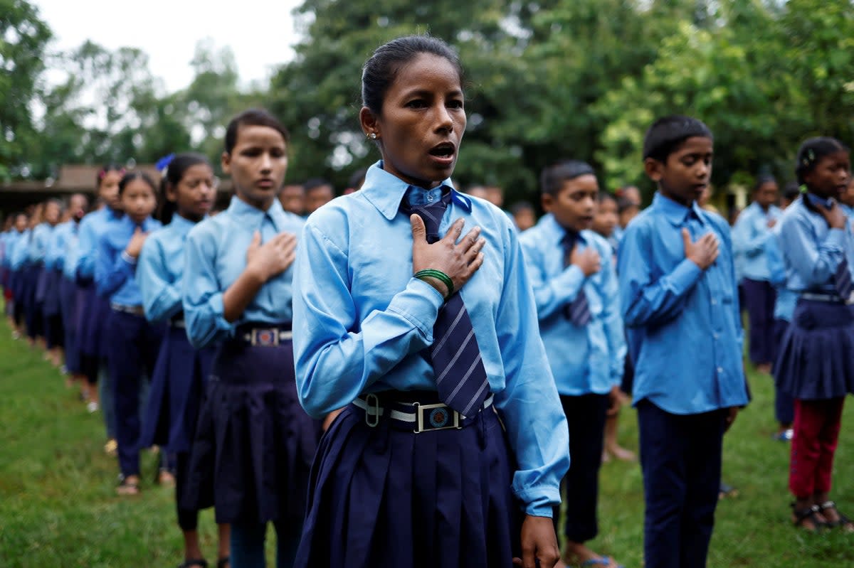 Parwati Sunar, 27, sings the national anthem of Nepal during assembly at Jeevan Jyoti secondary school in Punarbas (Reuters)
