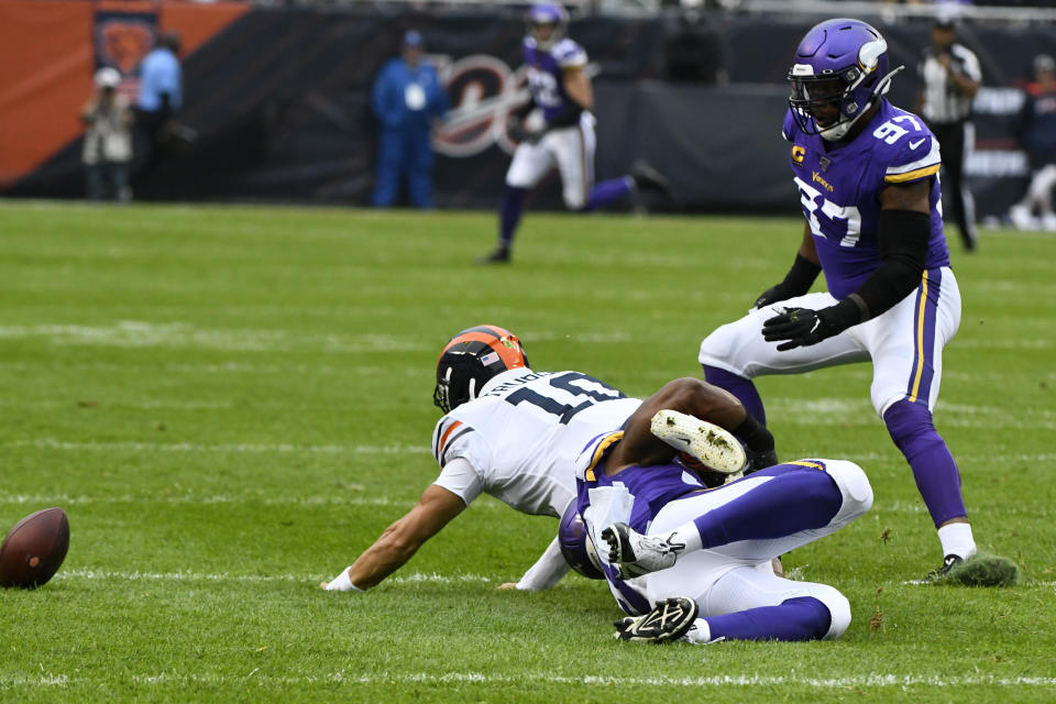 Chicago Bears quarterback Mitchell Trubisky (10) is injured as he fumbles and is pulled down by Minnesota Vikings defensive end Danielle Hunter and Vikings defensive end Everson Griffen (97) watches during the half of an NFL football game Sunday, Sept. 29, 2019, in Chicago. (AP Photo/Matt Marton)