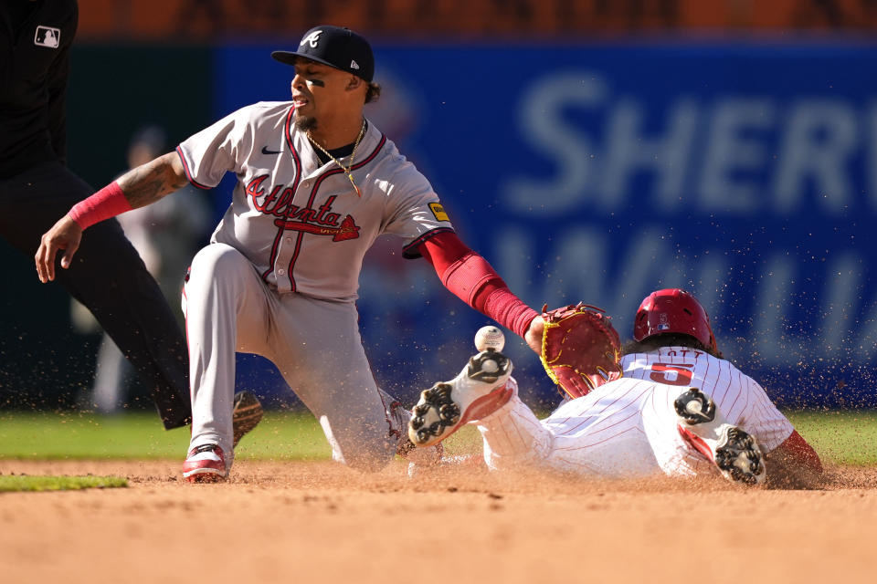 Philadelphia Phillies' Bryson Stott, right, steals second base past Atlanta Braves shortstop Orlando Arcia during the fifth inning of an opening-day baseball game, Friday, March 29, 2024, in Philadelphia. (AP Photo/Matt Slocum)