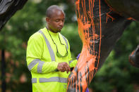 <p>A municipal worker attempts to remove paint from a monument dedicated to Confederate soldier John B. Castleman that was vandalized late Saturday night in Louisville, Ky., Aug.14, 2017. (Photo: Bryan Woolston/Reuters) </p>