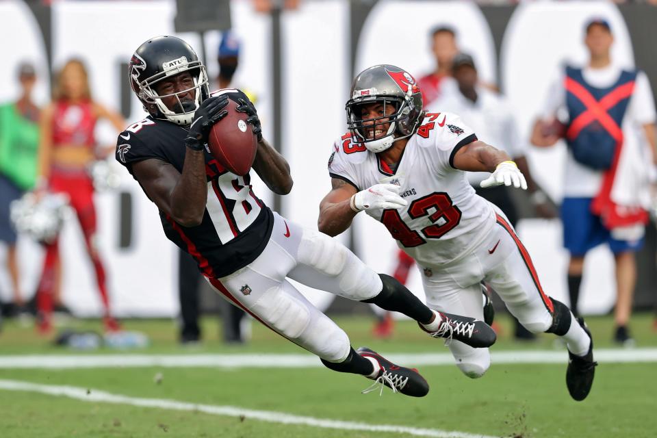FILE - Atlanta Falcons wide receiver Calvin Ridley (18) makes a diving touchdown reception in front of Tampa Bay Buccaneers defensive back Ross Cockrell (43) during the second half of an NFL football game in Tampa, Fla., Sunday, Sept. 19, 2021. Atlanta Falcons owner Arthur Blank says the team must have a succession plan at quarterback even while counting on Matt Ryan to continue as the starter in 2022. The Falcons face more complicated decisions at wide receiver, where Calvin Ridley's status remains uncertain. (AP Photo/Mark LoMoglio, File)