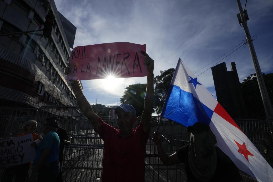 A demonstrator protests against a recently approved mining contract between the government and Canadian mining company First Quantum, outside the National Assembly in Panama City, Monday, Oct. 23, 2023. (AP Photo/Arnulfo Franco)