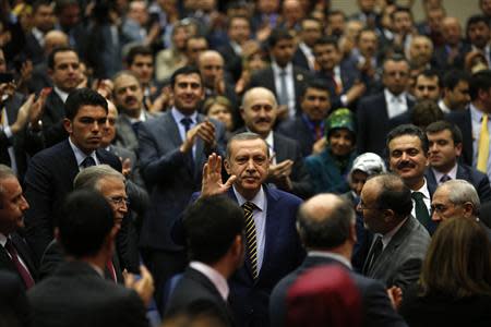 Turkey's Prime Minister Tayyip Erdogan greets members of his ruling AK Party (AKP) as he attends a meeting at party headquarters in Ankara December 25, 2013. REUTERS/Umit Bektas