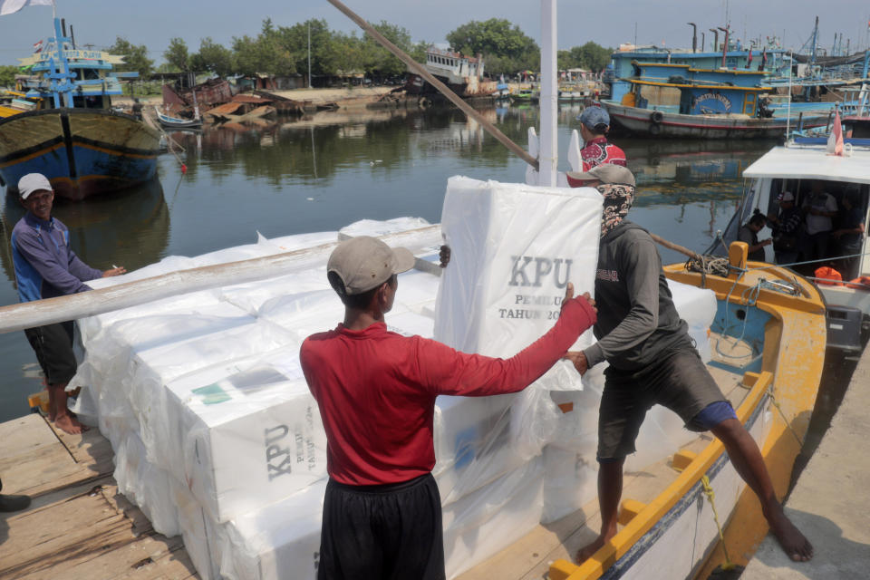 Workers load ballot boxes onto a boat for distribution to polling stations ahead of Feb. 14 election in Probolinggo, Indonesia, Monday, Feb. 12, 2024. Indonesia, the world's third-largest democracy, will open its polls on Wednesday to nearly 205 million eligible voters in presidential and legislative elections, the fifth since Southeast Asia's largest economy began democratic reforms in 1998. (AP Photo/Trisnadi)