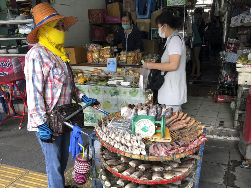 Una vendedora ambulante ofrece pescado fresco en un mercado del centro de Bangkok el 23 de diciembre del 2020. (AP Photo/Adam Schreck)