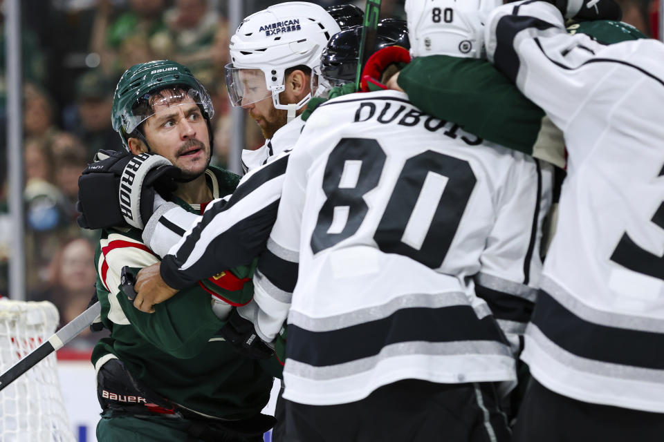 Minnesota Wild right wing Mats Zuccarello, left, and Los Angeles Kings defenseman Vladislav Gavrikov, second from left, get into a scrap during the second period of an NHL hockey game Thursday, Oct. 19, 2023, in St. Paul, Minn. (AP Photo/Matt Krohn)