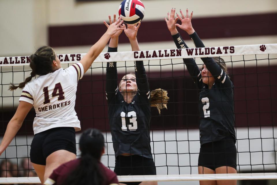 Calallen's Jordyn Thibodeaux (13) and Ashley Robertson (2) rise to block a spike attempt in a volleyball match against Tuloso-Midway at Calallen High School in Corpus Christi, Texas on Tuesday, Sep. 27, 2022.